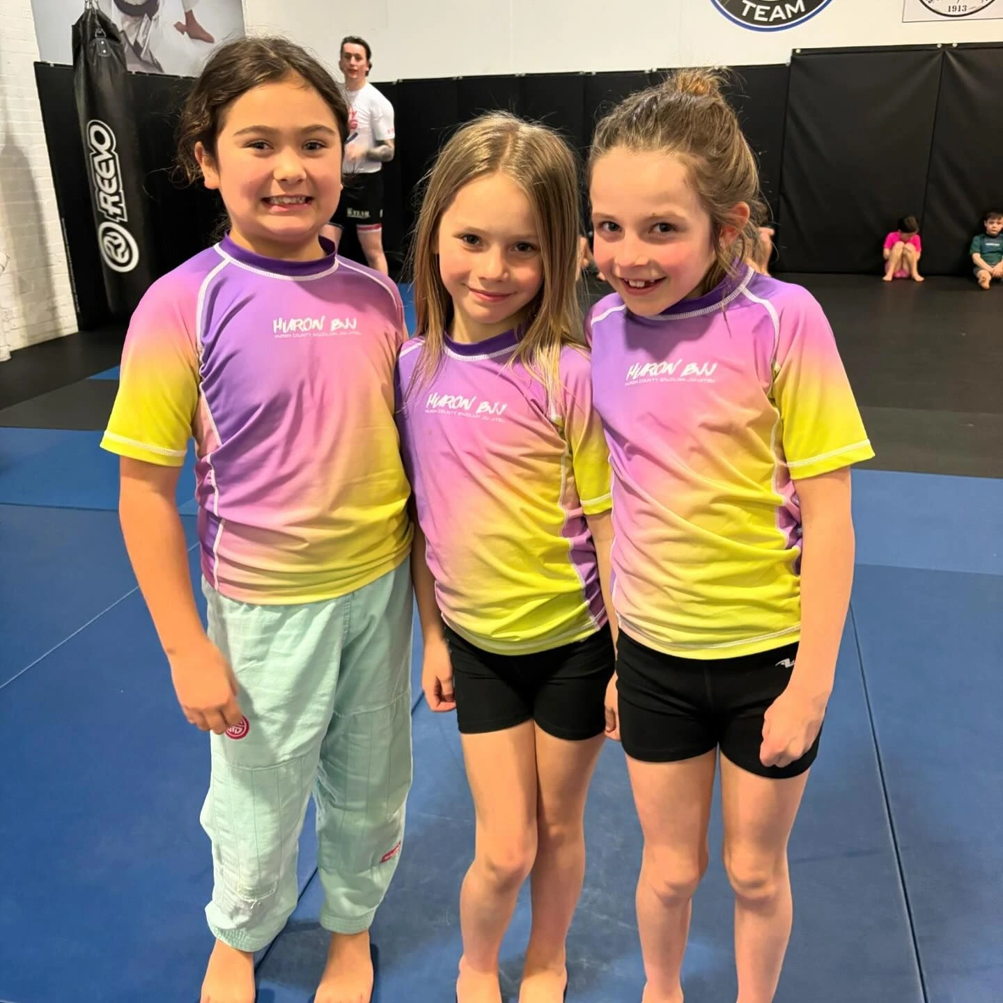 senior girls showing off huron bjj rash guards