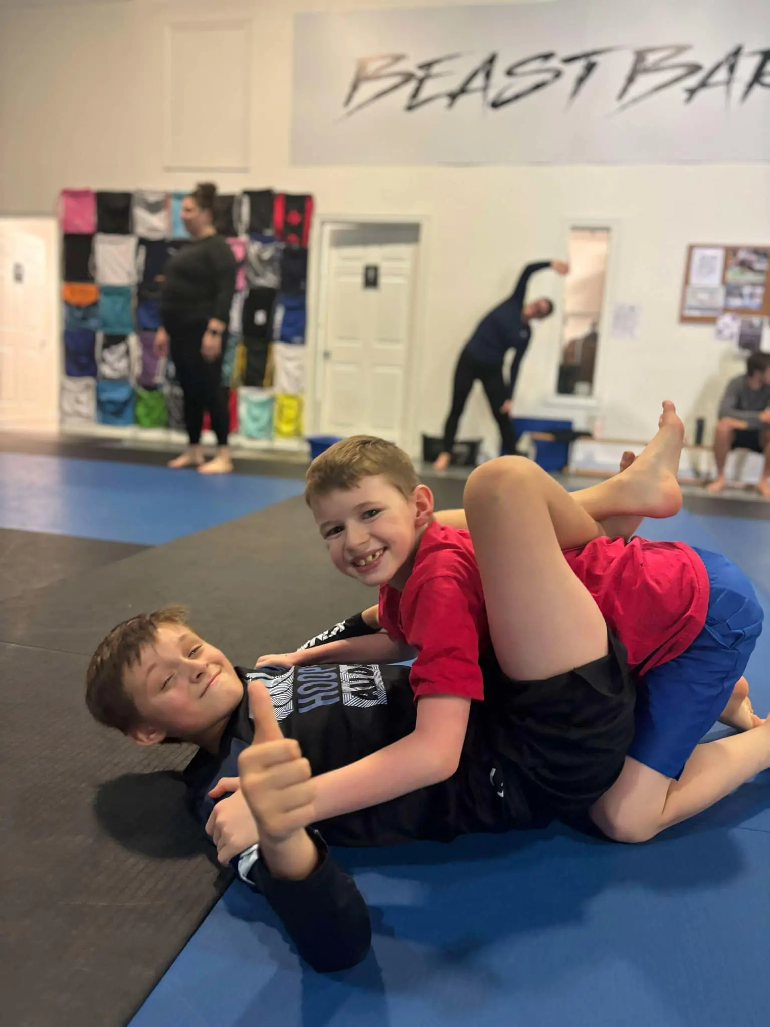 two boys sparing on the mat