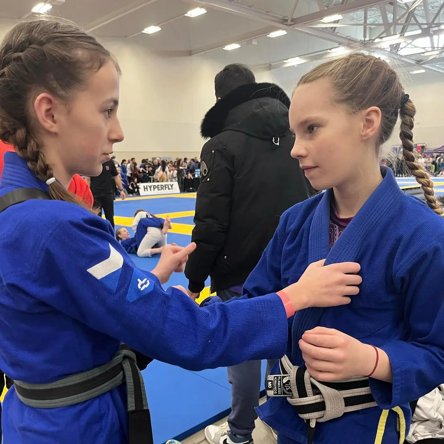 two girls helping each other with their moves before a competition