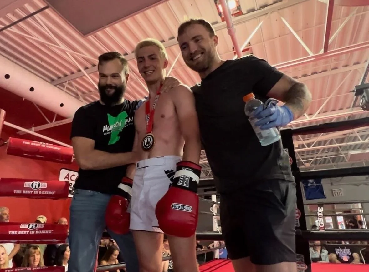 coach jason and jesse with student at boxing match