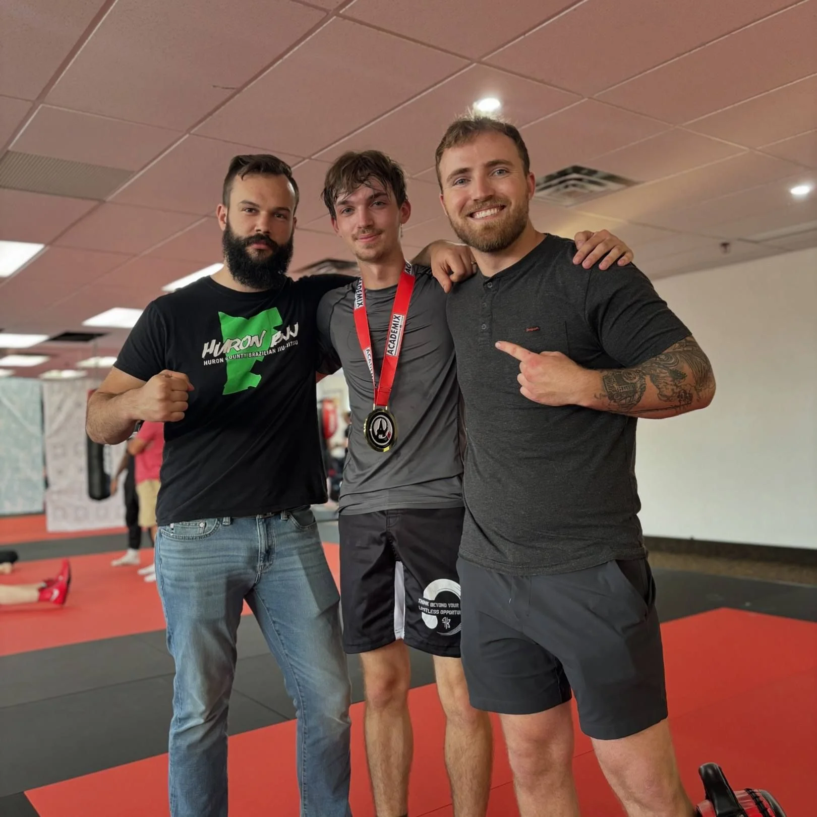 coach jason and jesse with student at boxing match